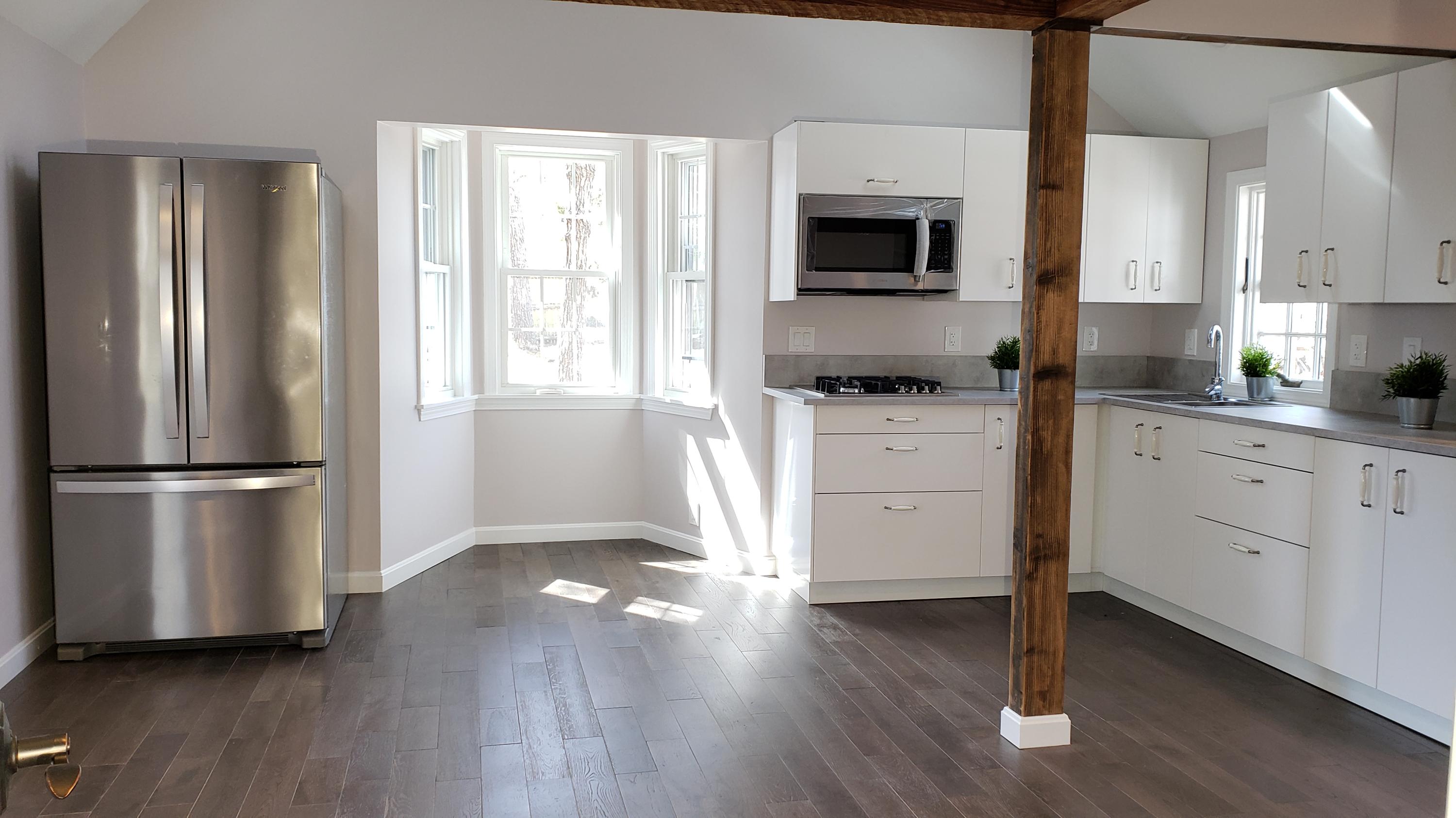 9 Bells Neck Road, Unit 3 West Harwich, MA 02671 - Photo 7 of 23 a kitchen with a refrigerator stove and wooden floor