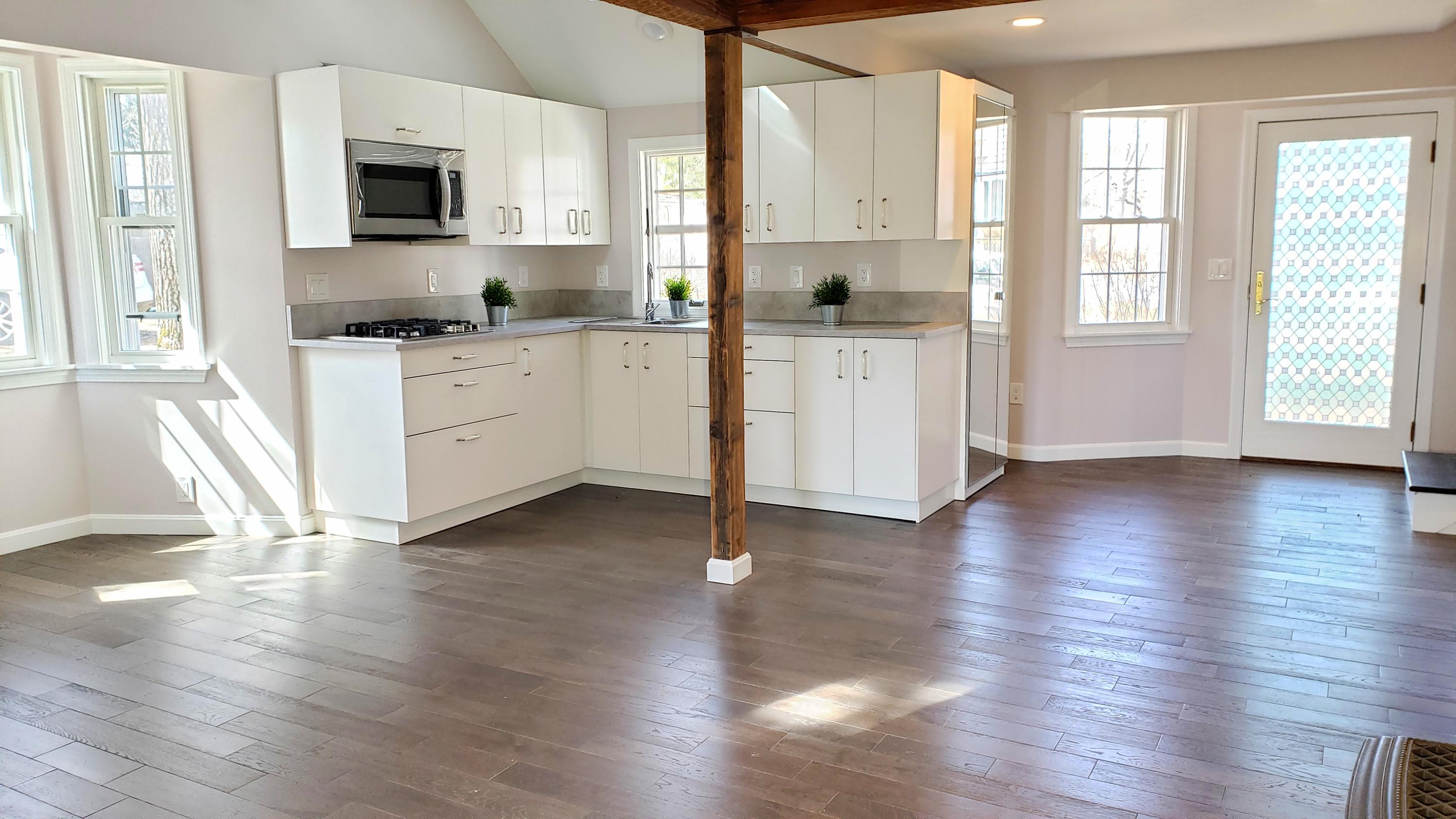 9 Bells Neck Road, Unit 3 West Harwich, MA 02671 - Photo 8 of 23 a kitchen with wooden floors and white cabinets