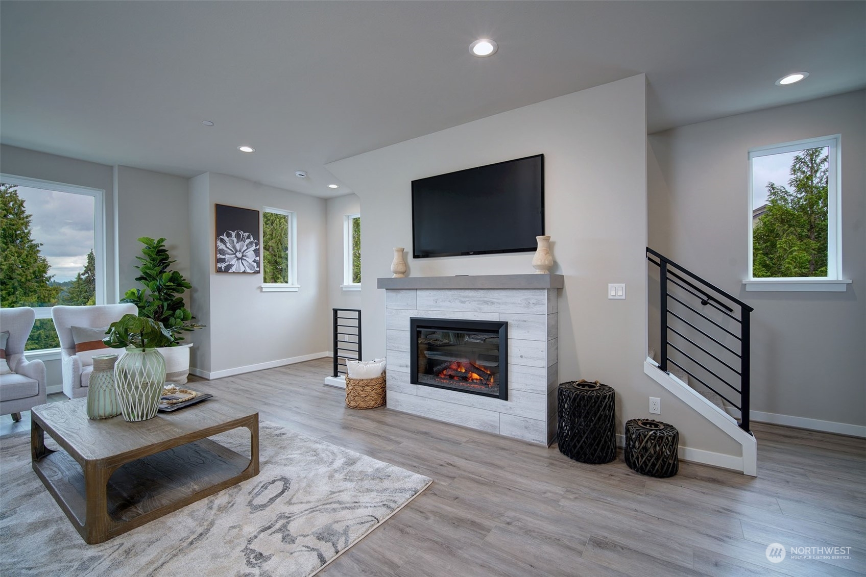 111 161st Place Southeast, Unit B7 Bothell, WA 98012 - Photo 6 of 40 a living room with furniture a flat screen tv and a fireplace