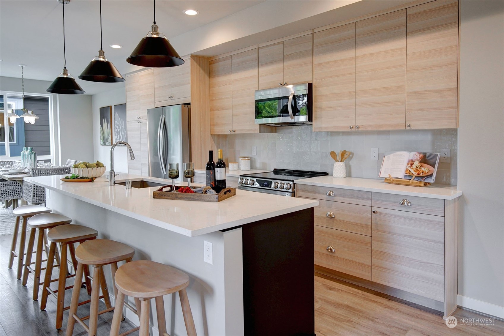 111 161st Place Southeast, Unit B7 Bothell, WA 98012 - Photo 10 of 40 a kitchen with kitchen island granite countertop a sink a center island stainless steel appliances and cabinets