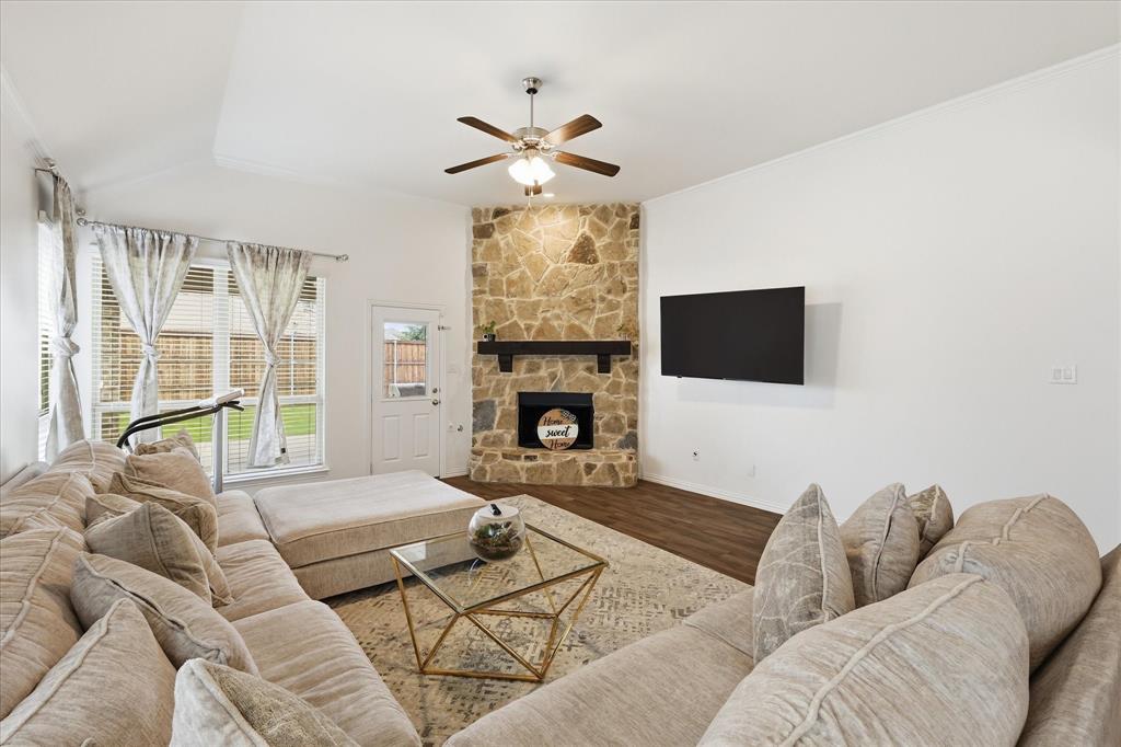 215 Equestrian Road Hickory Creek, TX 75065 - Photo 15 of 36 a living room with furniture a fireplace and a flat screen tv