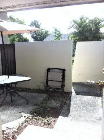 a backyard of a house with table and chairs