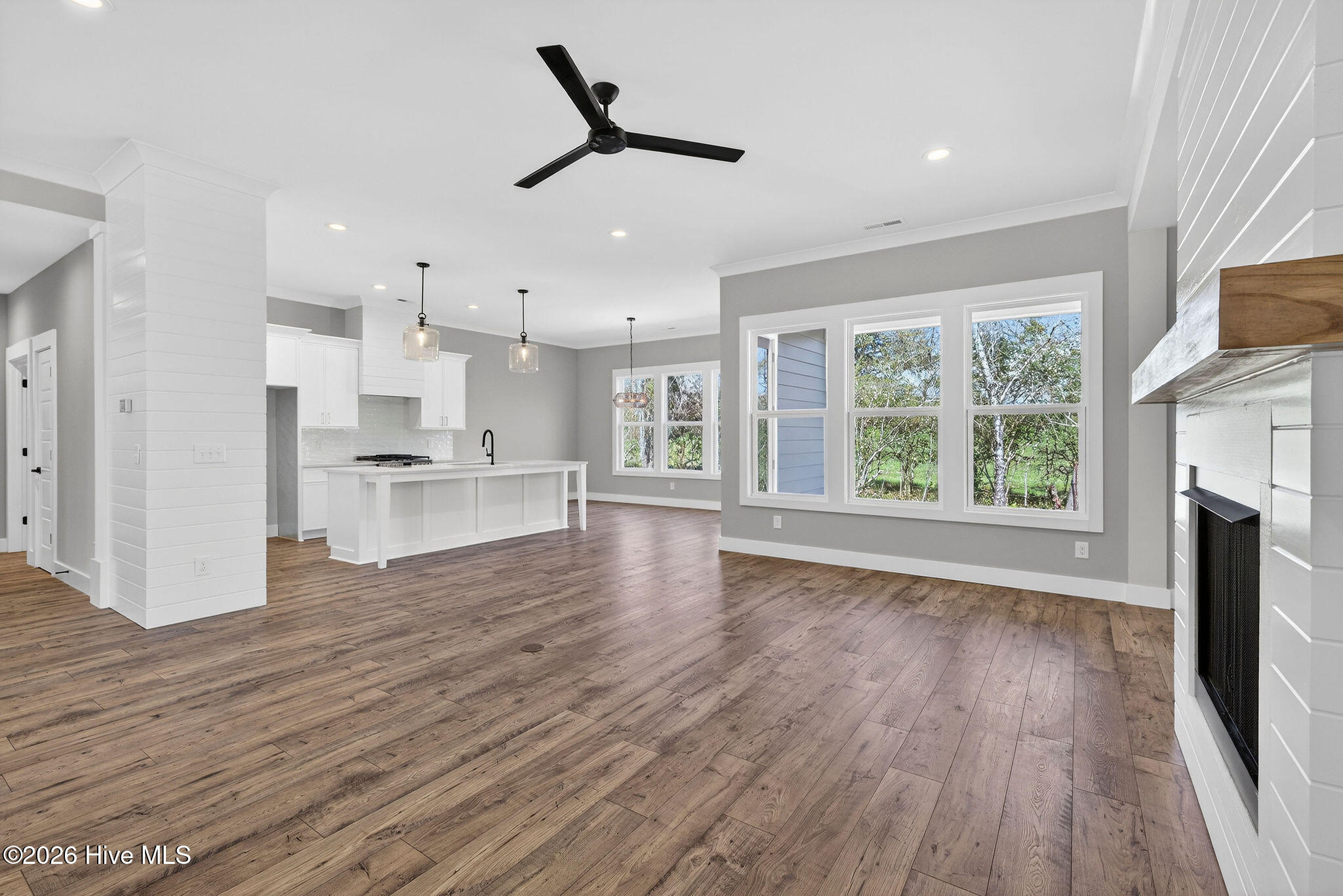 5988 Gray Squirrel Path Southport, NC 28461 - Photo 13 of 52 Living Room area with Shiplap fireplace and view to kitchen Island