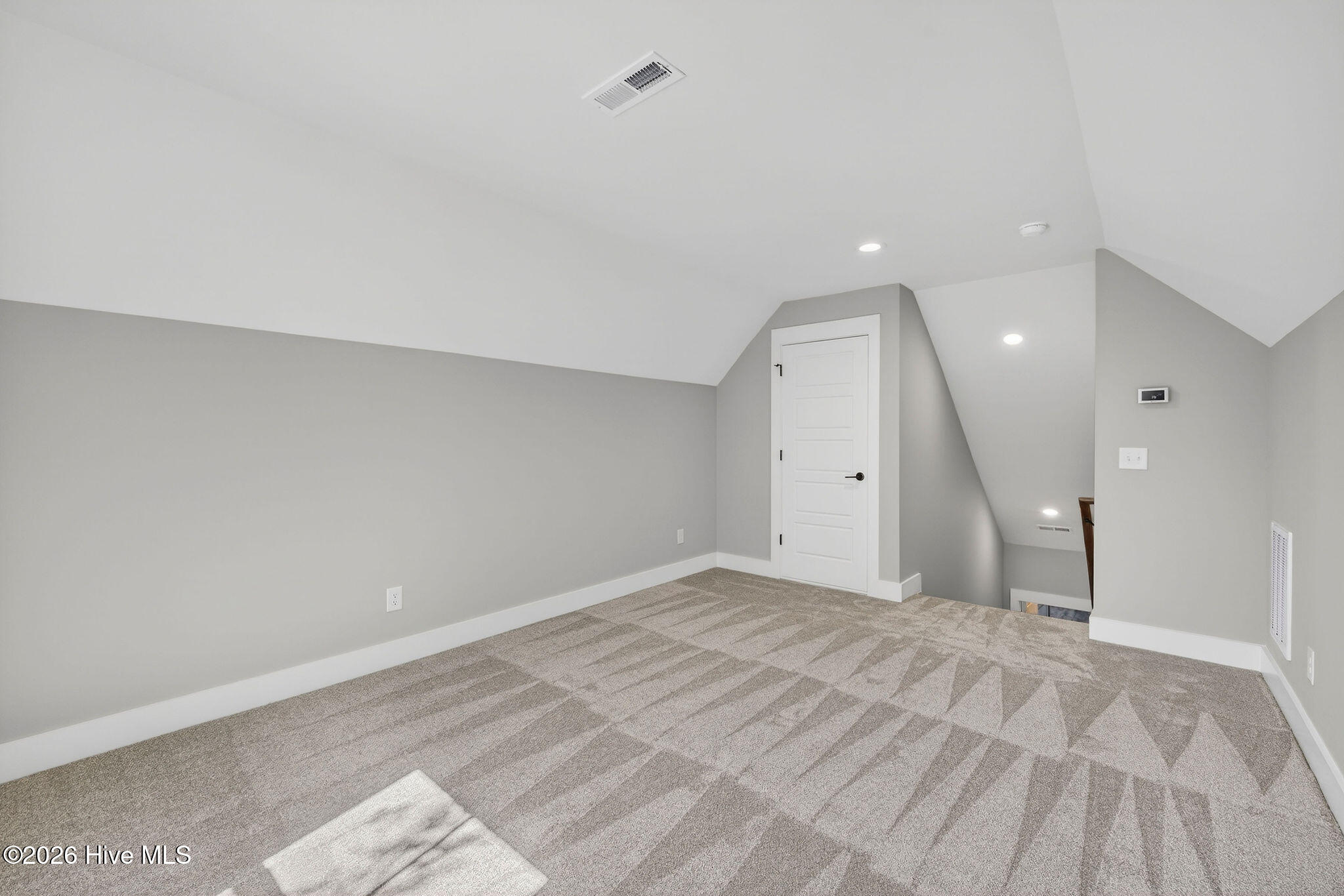 5988 Gray Squirrel Path Southport, NC 28461 - Photo 30 of 52 Bonus Room Bedroom 4 or perfect Home Office with walk-in floored attic storage.