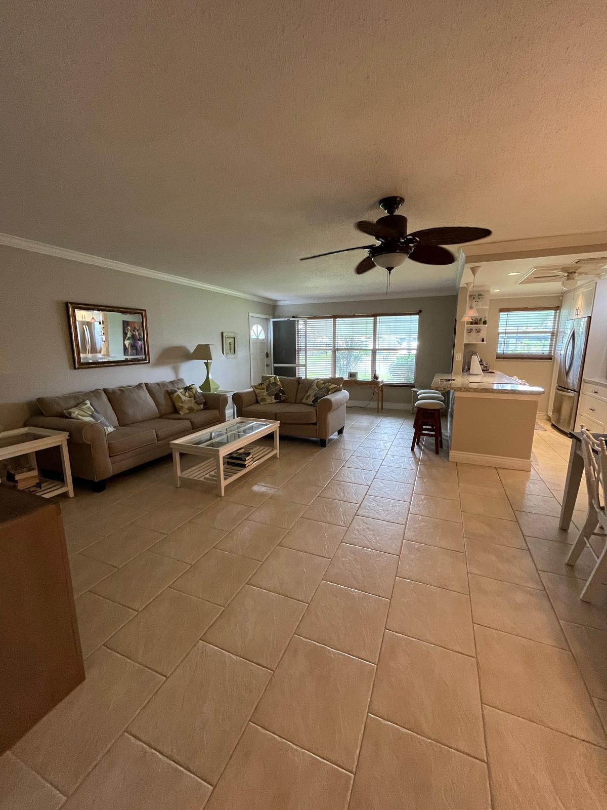 515 High Point, Unit C Delray Beach, FL 33445 - Photo 14 of 23 a living room with furniture a flat screen tv and a window