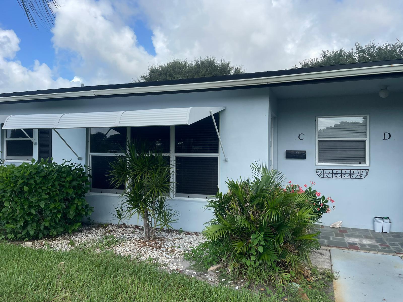 515 High Point, Unit C Delray Beach, FL 33445 - Photo 2 of 23 a house with trees in front of it