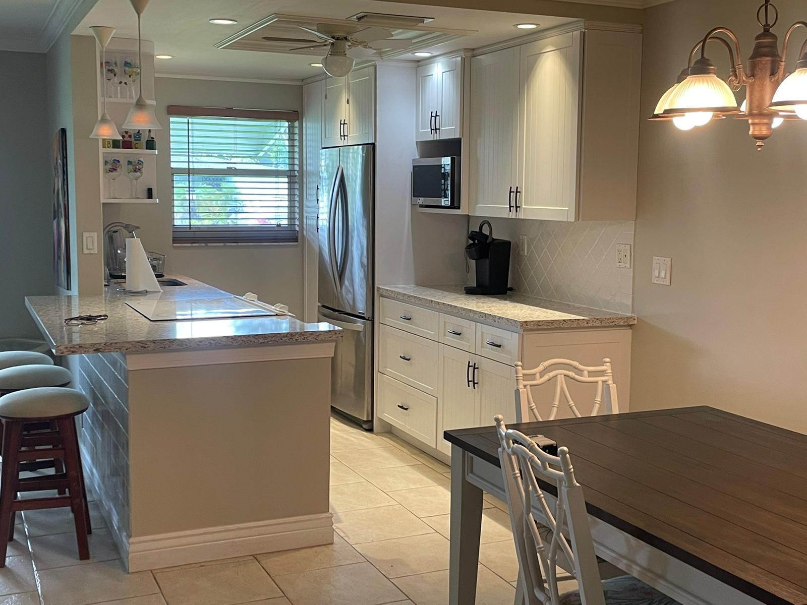 515 High Point, Unit C Delray Beach, FL 33445 - Photo 6 of 23 a kitchen with stainless steel appliances granite countertop a stove a sink and a refrigerator