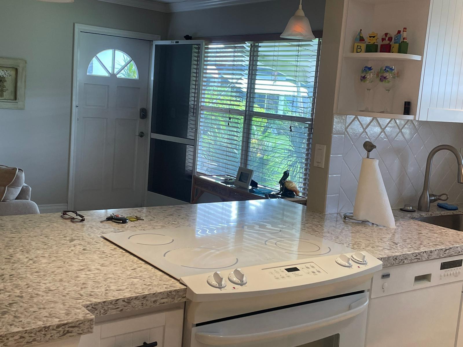 515 High Point, Unit C Delray Beach, FL 33445 - Photo 8 of 23 a kitchen with kitchen island a counter top space appliances and cabinets