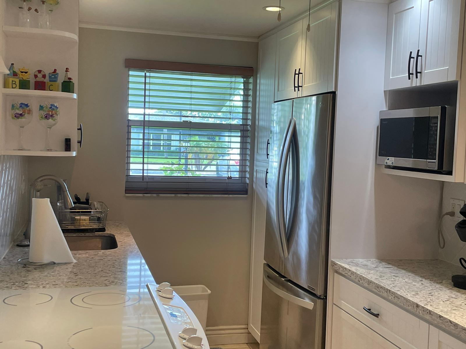 515 High Point, Unit C Delray Beach, FL 33445 - Photo 10 of 23 a kitchen with stainless steel appliances granite countertop a refrigerator and a sink