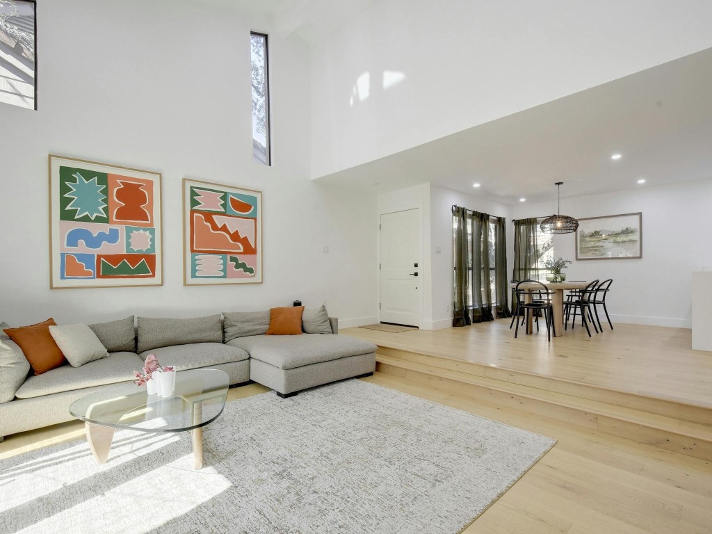 a living room with furniture and kitchen view