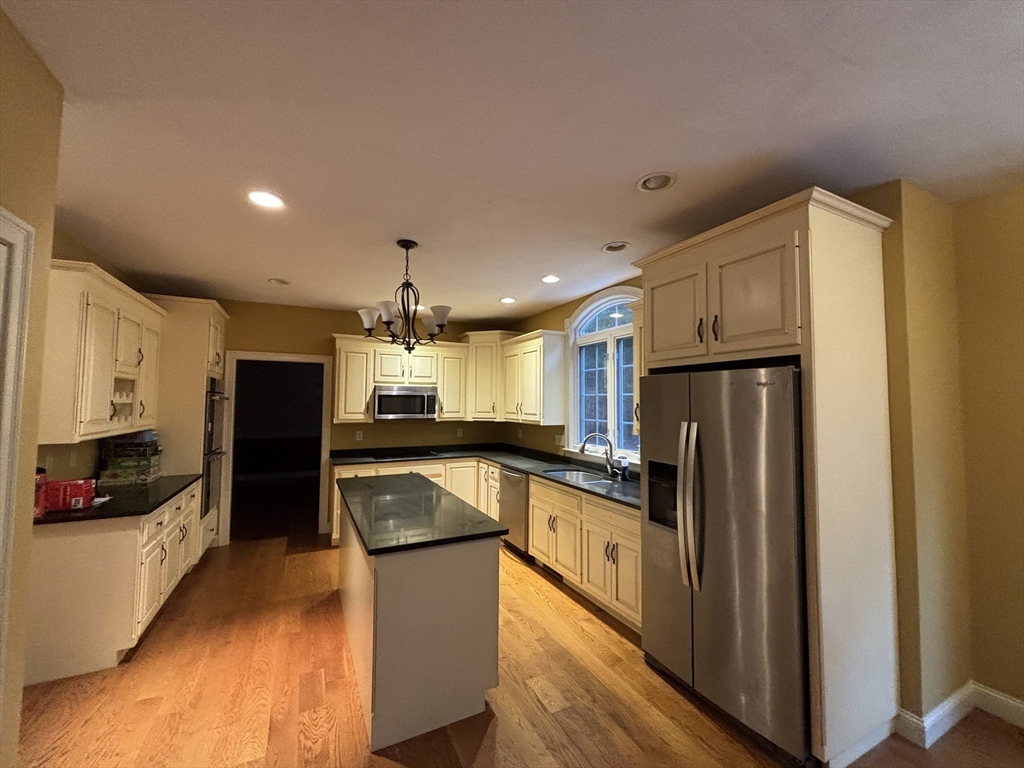 1 Tyler Road Upton, MA 01568 - Photo 4 of 12 a kitchen with granite countertop a refrigerator and a sink