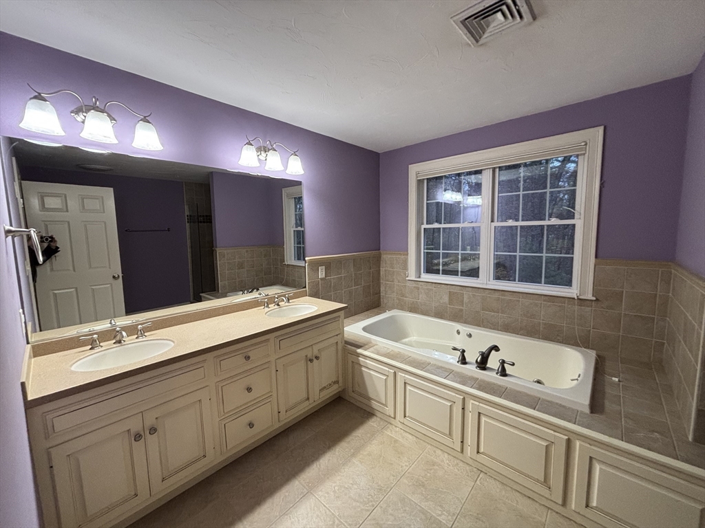 1 Tyler Road Upton, MA 01568 - Photo 9 of 12 a spacious bathroom with a tub sink and mirror