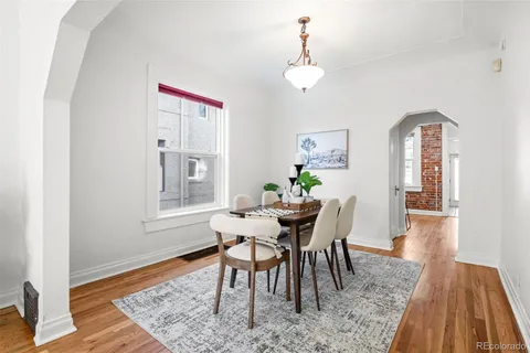a kitchen with stainless steel appliances a sink cabinets and a wooden floor
