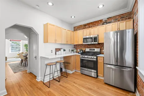 a kitchen with stainless steel appliances granite countertop a refrigerator stove and microwave