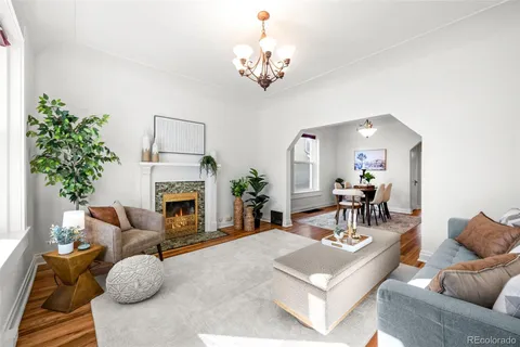 a living room with furniture a fireplace and a table