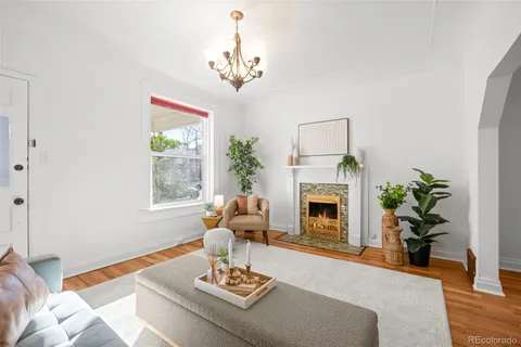 a living room with furniture and a potted plant