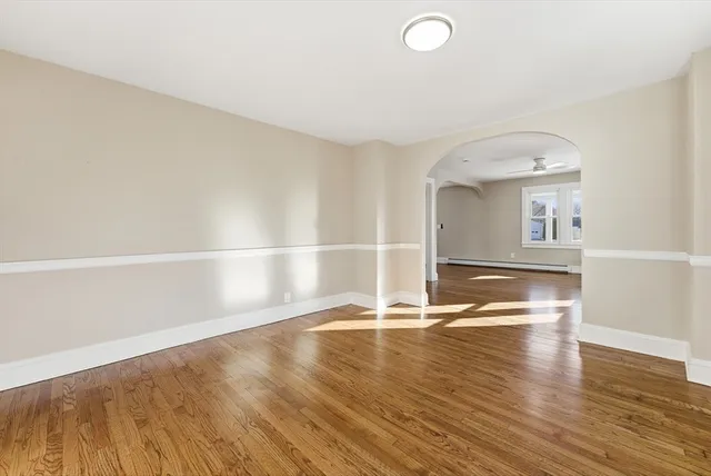 a view of empty room with wooden floor