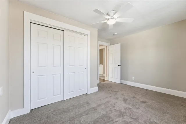 a view of an empty room with a ceiling fan