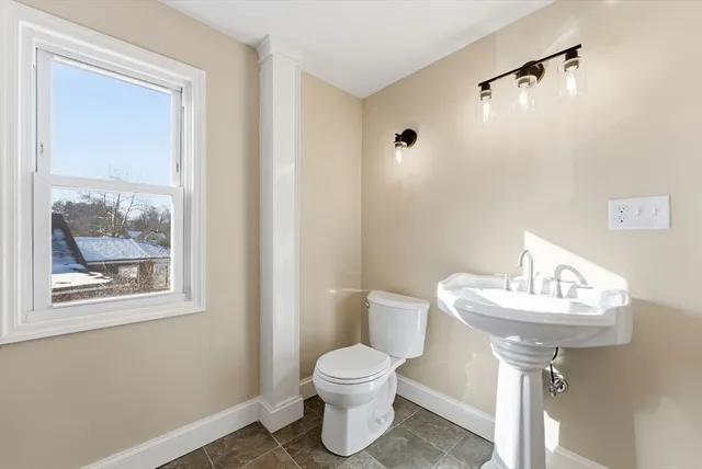a bathroom with a sink toilet and a mirror
