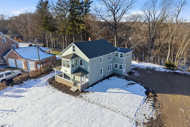 a view of a house with a yard covered in snow