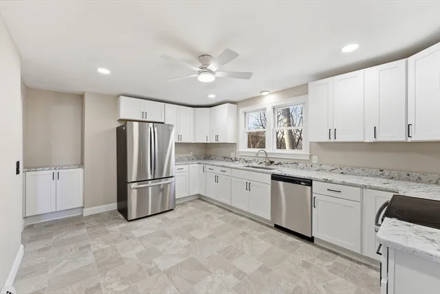 a kitchen with a refrigerator and a sink