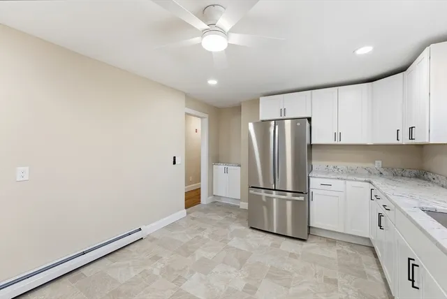 a kitchen with stainless steel appliances granite countertop a refrigerator and a refrigerator
