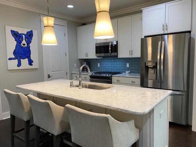 290 Jack Knife Drive Watersound, FL 32461 - Photo 10 of 40 a kitchen with stainless steel appliances granite countertop a sink a microwave a refrigerator and a stove