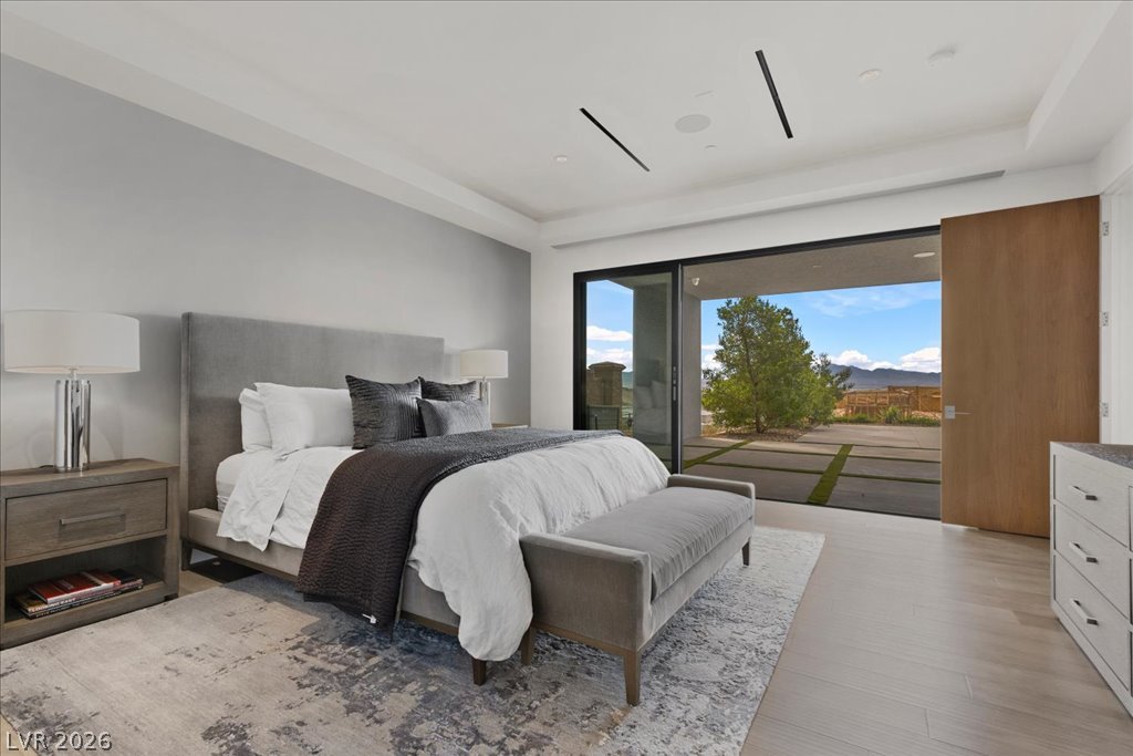 657 Ridgestone Rim Court Henderson, NV 89012 - Photo 65 of 97 Sliding glass doors open directly to the outdoor patio from this modern bedroom.