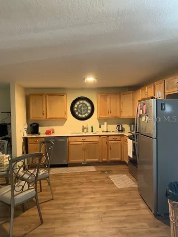 a kitchen with a refrigerator and furniture