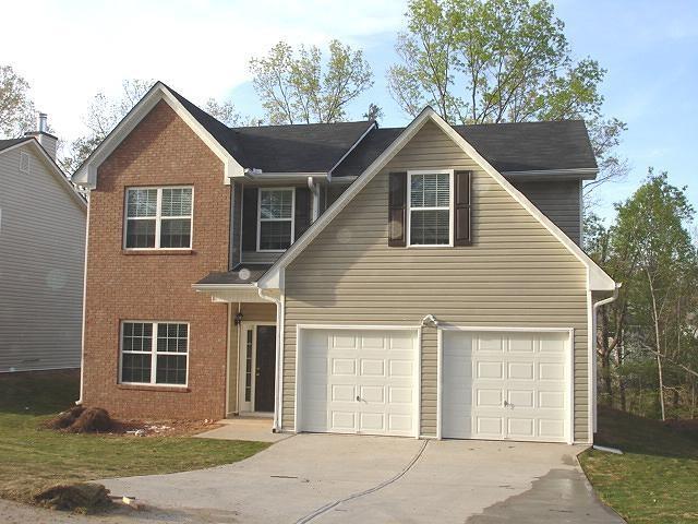 a front view of a house with yard