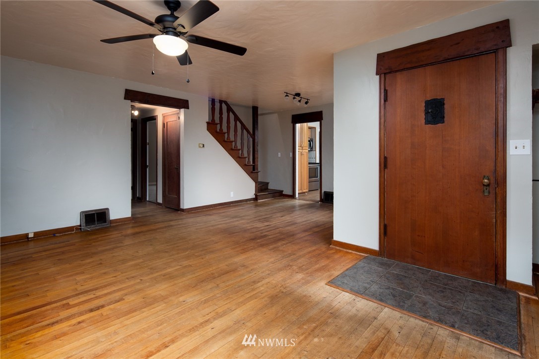 209 Parkridge Road Bellingham, WA 98225 - Photo 7 of 33 a view of a hallway with wooden floor and a ceiling fan