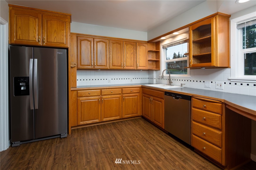 209 Parkridge Road Bellingham, WA 98225 - Photo 9 of 33 a kitchen with stainless steel appliances granite countertop wooden cabinets a refrigerator and sink