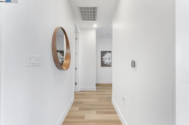 a bedroom with a bed and next to a window