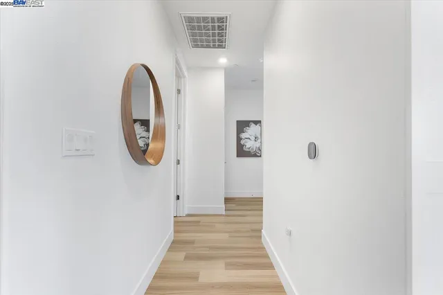 a bedroom with a bed and next to a window