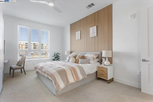 a bedroom with two beds and painted walls
