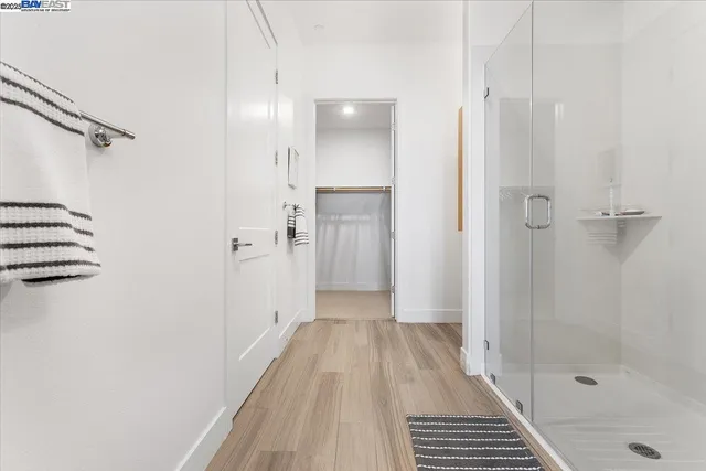 a white toilet sitting next to a shower