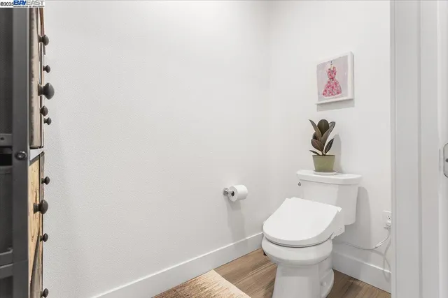 a view of a hallway with wooden floor and entryway