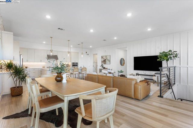 a dining room with furniture and wooden floor