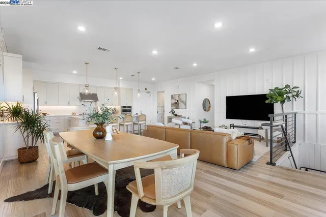 a dining room with furniture and wooden floor