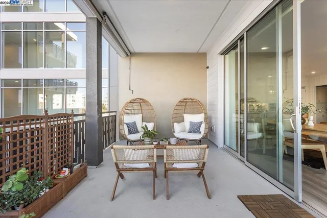 a view of hall way with furniture and a potted plant