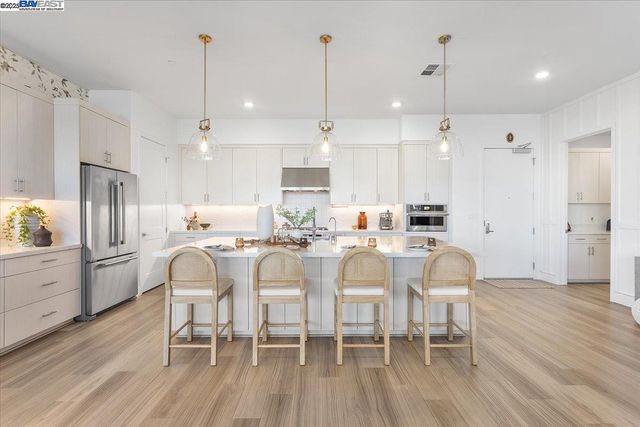 a large kitchen with a table and chairs