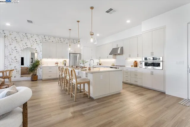 a kitchen with stainless steel appliances kitchen island granite countertop a sink and cabinets