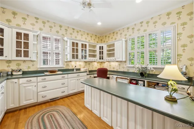 a kitchen with granite countertop a sink a stove top oven and cabinets