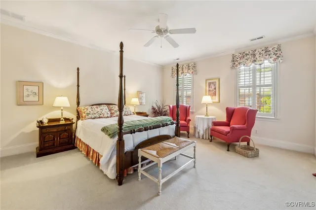 a bedroom with a bed a chandelier and flat screen tv
