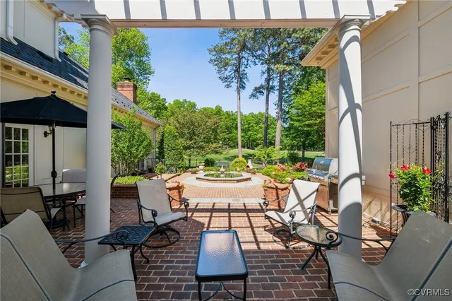 a view of a patio with table and chairs potted plants