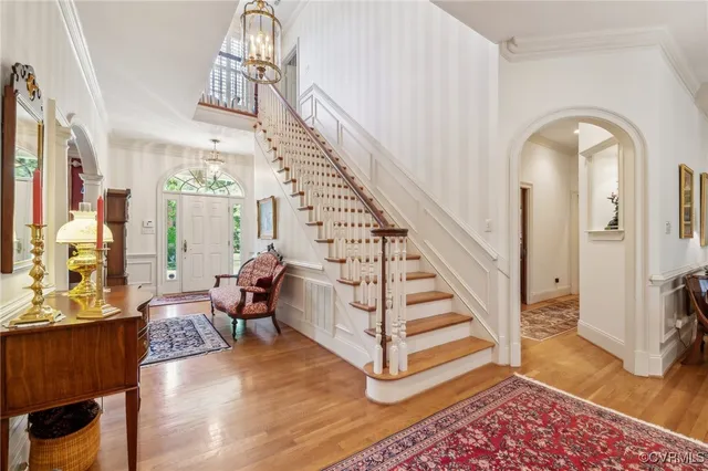 a view of entryway and hall with wooden floor