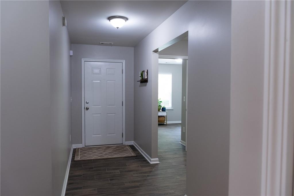 165 Pine Ridge Road Covington, GA 30016 - Photo 4 of 28 a view of hallway with closet and wooden floor