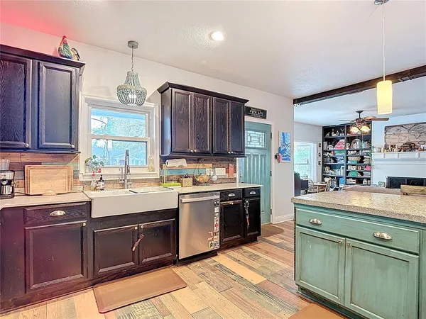 a view of a kitchen with fridge and workspace