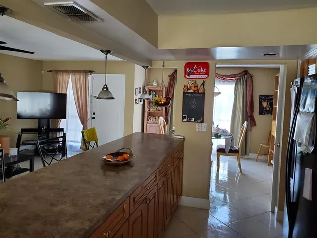 a view of a kitchen with a dining table chairs and a wooden floor