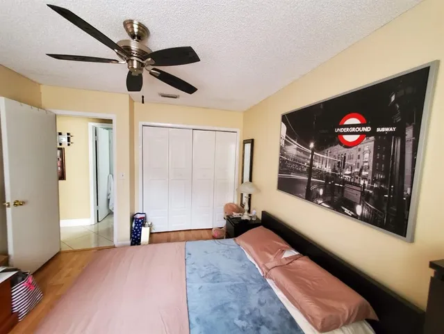 a bedroom with furniture and a flat screen tv
